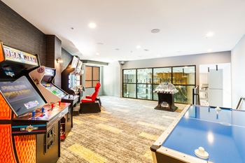 A games room with a pool table and a fireplace